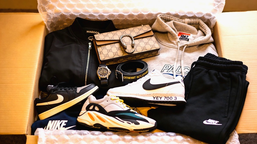 CNFans haul box — Yeezy 700, Jordan 1, Gucci bag, Palace hoodie